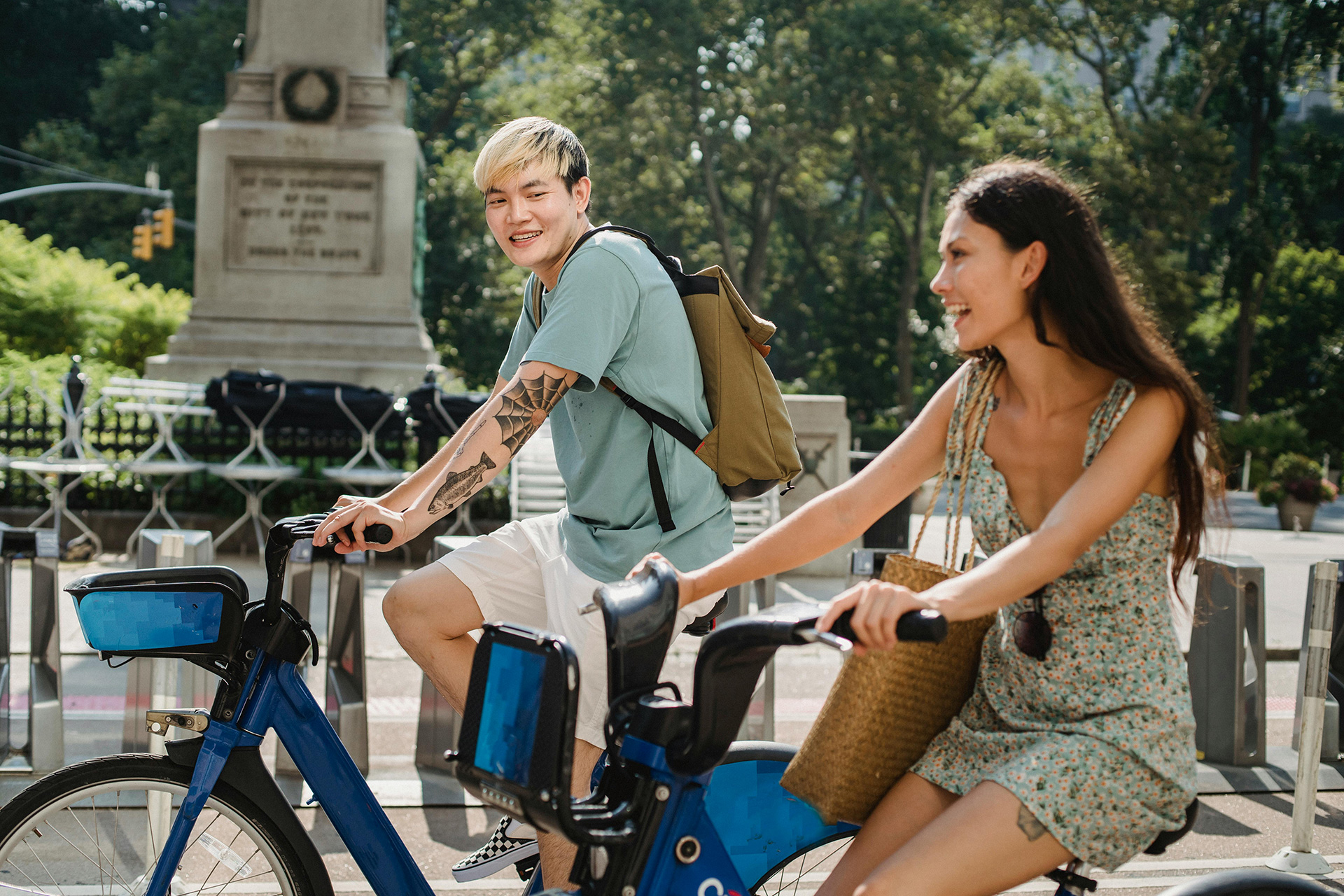 Two people smiling riding bikes